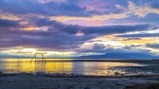 A colorful sunset sky reflection on the Salton Sea at Bombay Beach. 