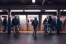 A subway train moves down the platform in New York City. 