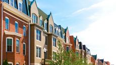 A row of townhouses on a sunny day.