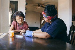 A woman receives healthcare at home.