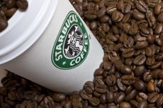 Starbucks cup with coffee beans