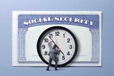 A man moving a giant clock's hands in front of a Social Security card.