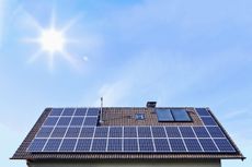 pictudre of a home rooftop covered in solar panels in a bright sky